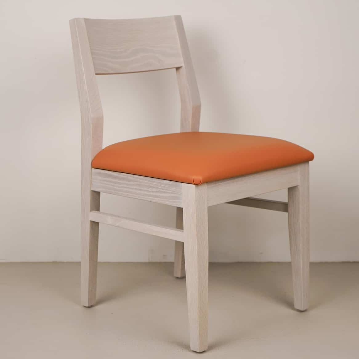 pumpkin faux leather seat on white oak chair