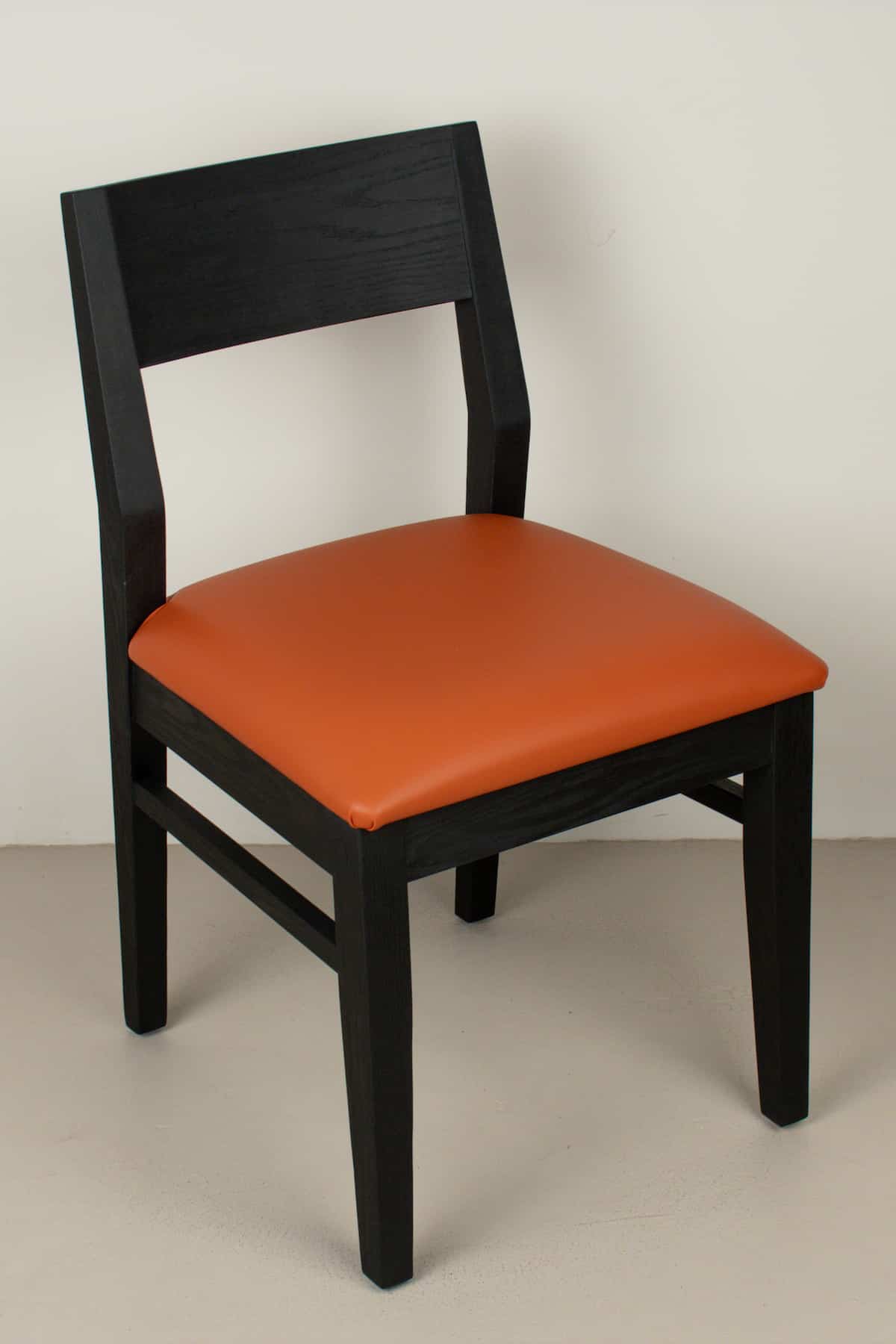 pumpkin faux leather seat on black oak chair