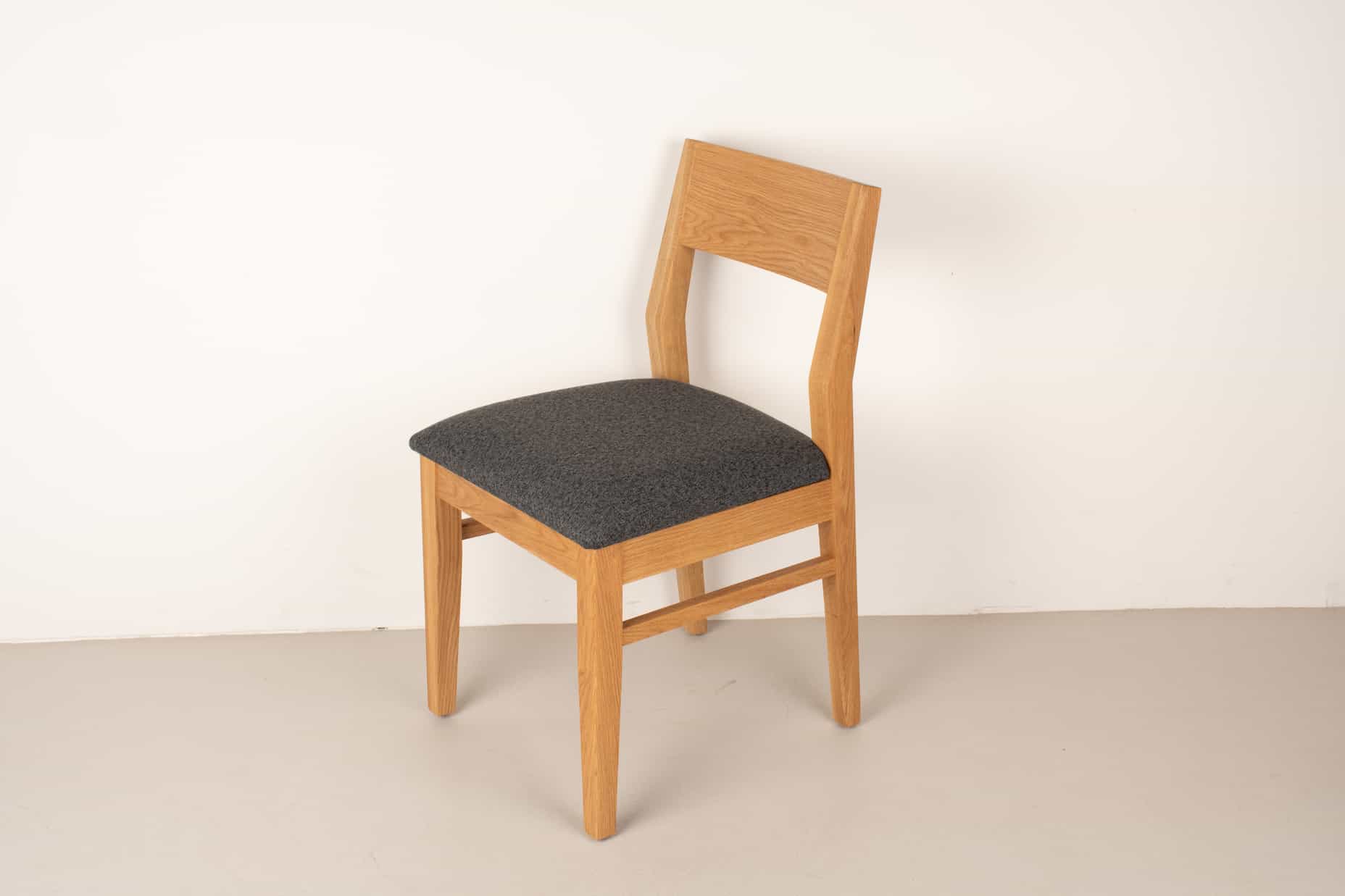 charcoal fabric seat on natural oak chair