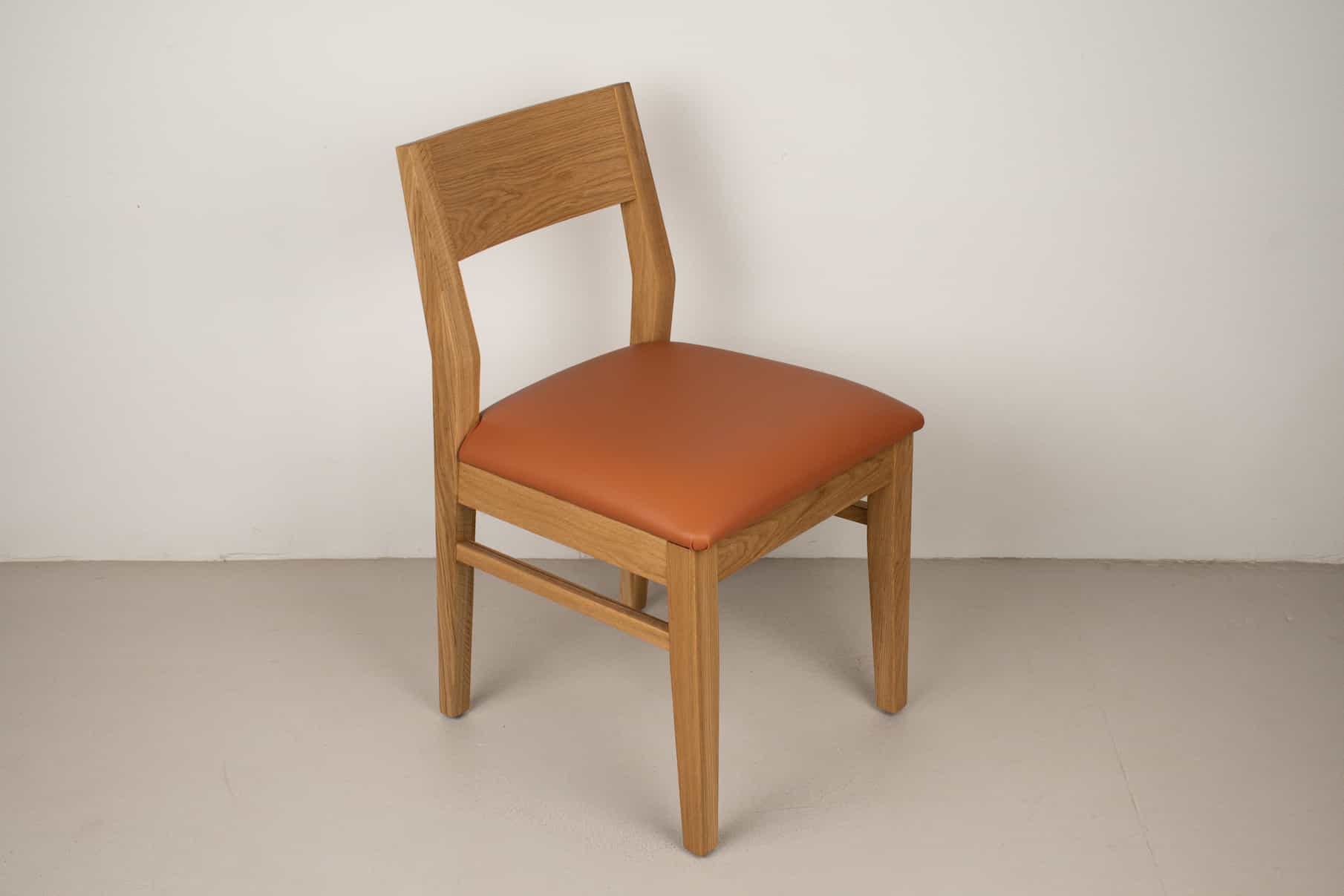 pumpkin faux leather seat on natural oak chair