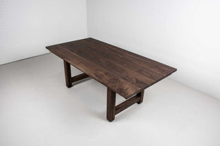 large extendable farmhouse table in blackened walnut on chunky H legs