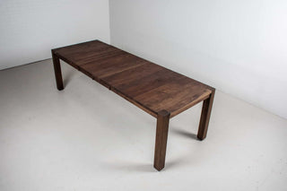 blackened walnut extendable table on modern exposed parsons base