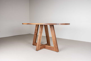 mid century oval table in walnut on single cross pedestal base
