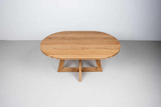 oval white oak dining table on single cross pedestal base