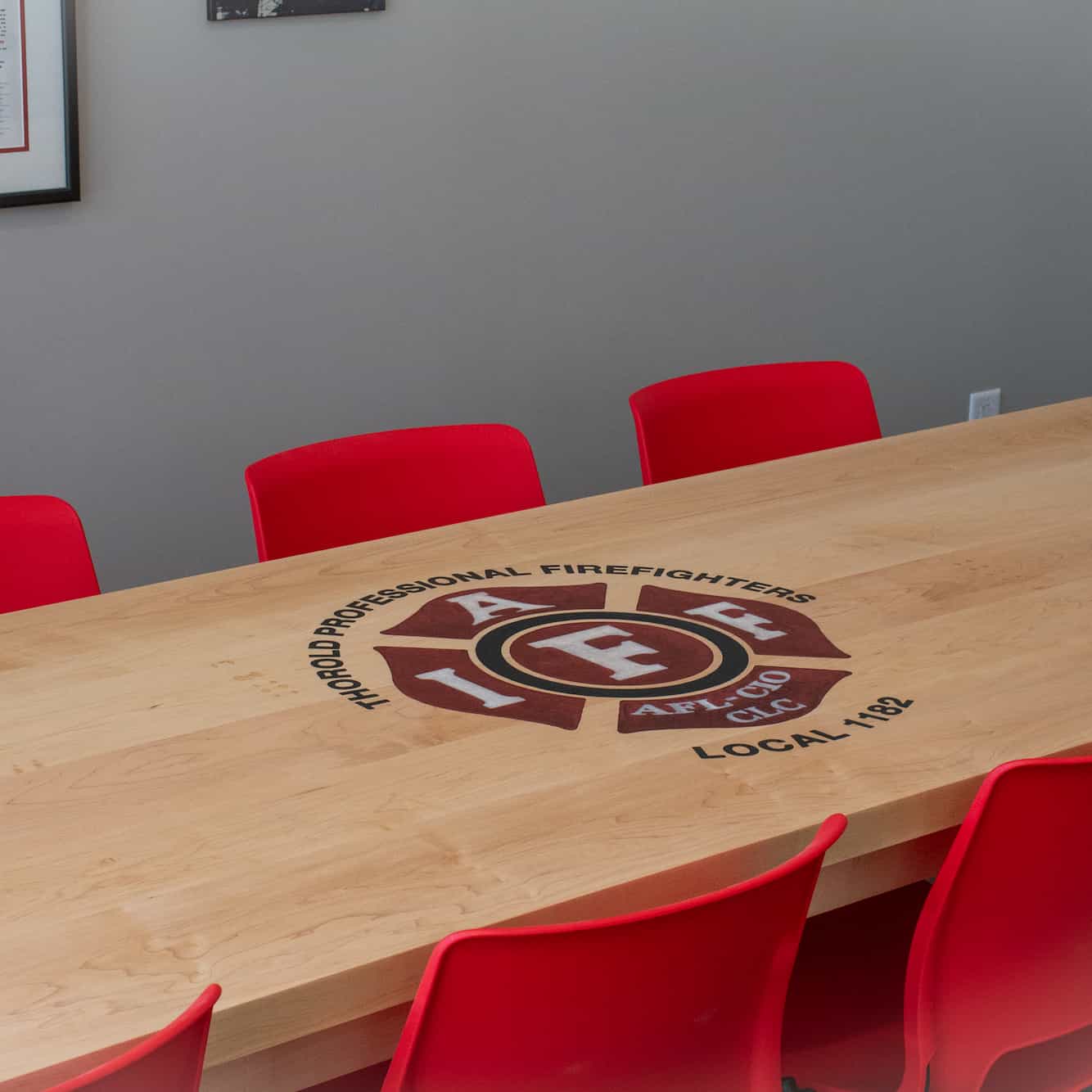 custom maple conference table with inlaid epoxy logo