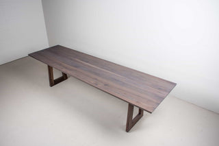 weathered walnut dining table on matching walnut trapezoid legs