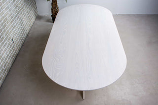 white oval oak racetrack table on moraine pedestal base