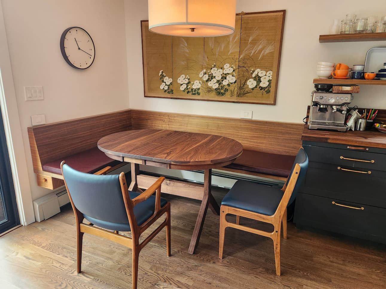 extendable oval table in Walnut paired with a corner banquette