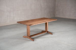 classic extendable wood dining table on a trestle base