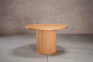 an expandable table on fluted pedestal base