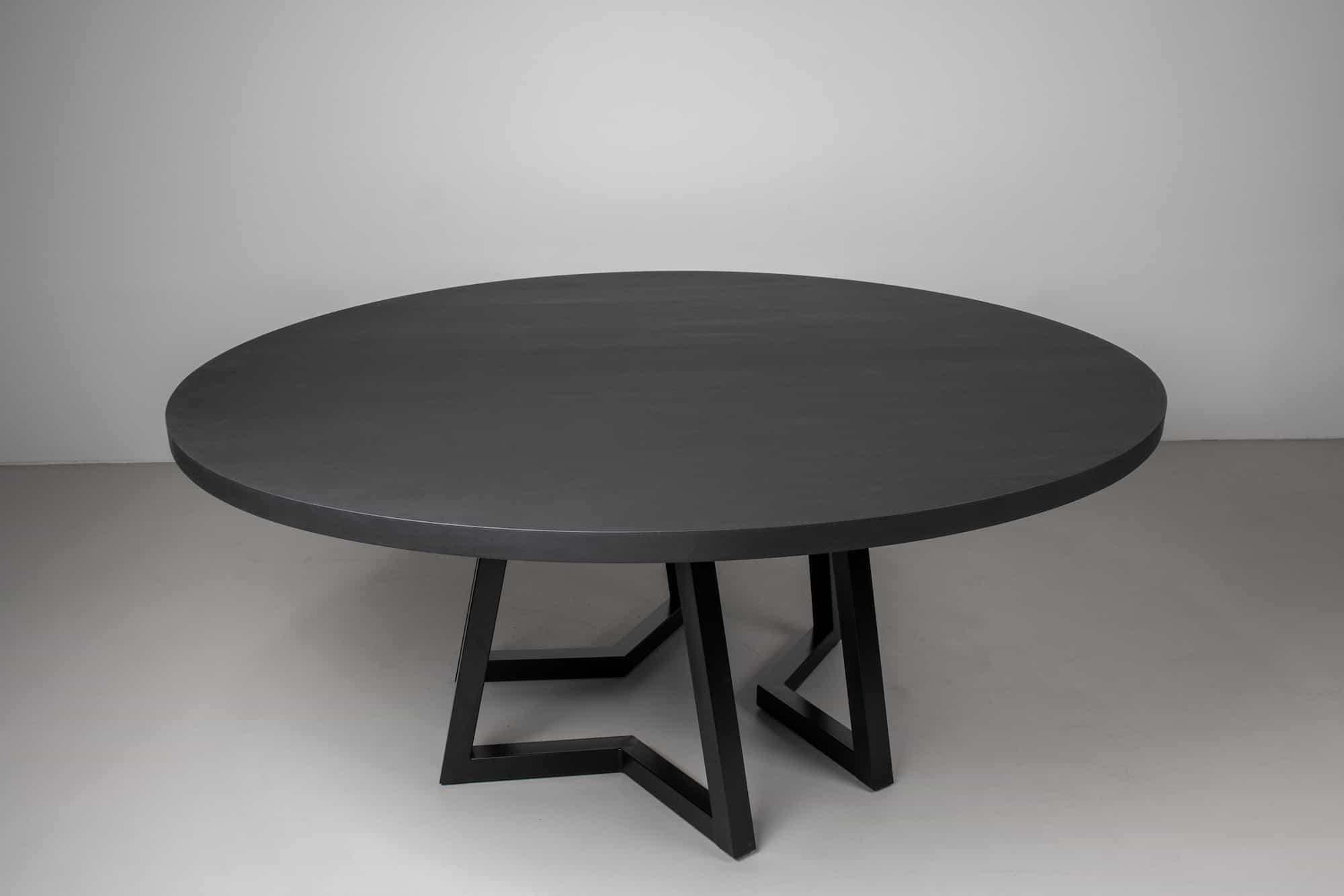 large round maple table in black on steel legs