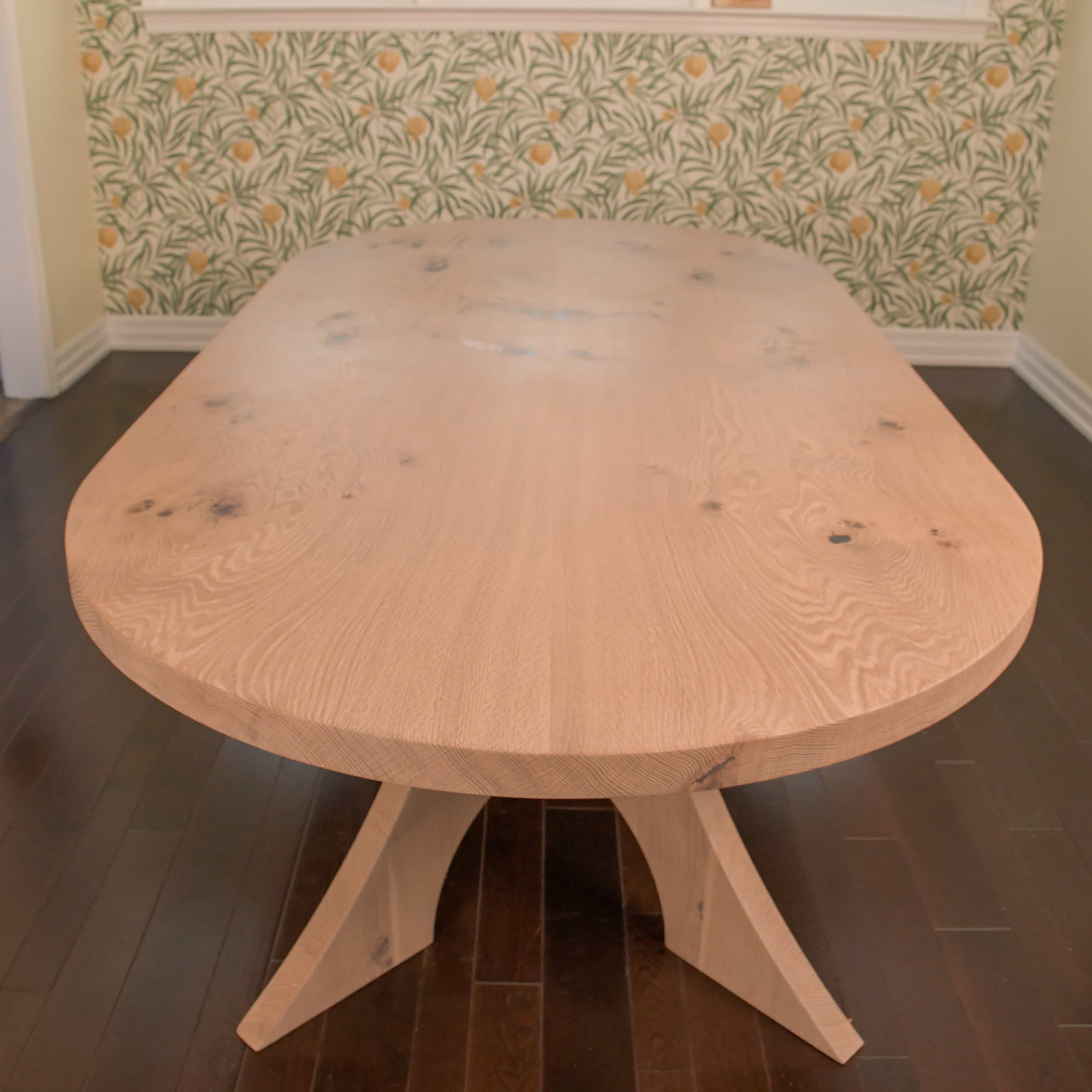 maple racetrack oval bookmatch table in a dining room
