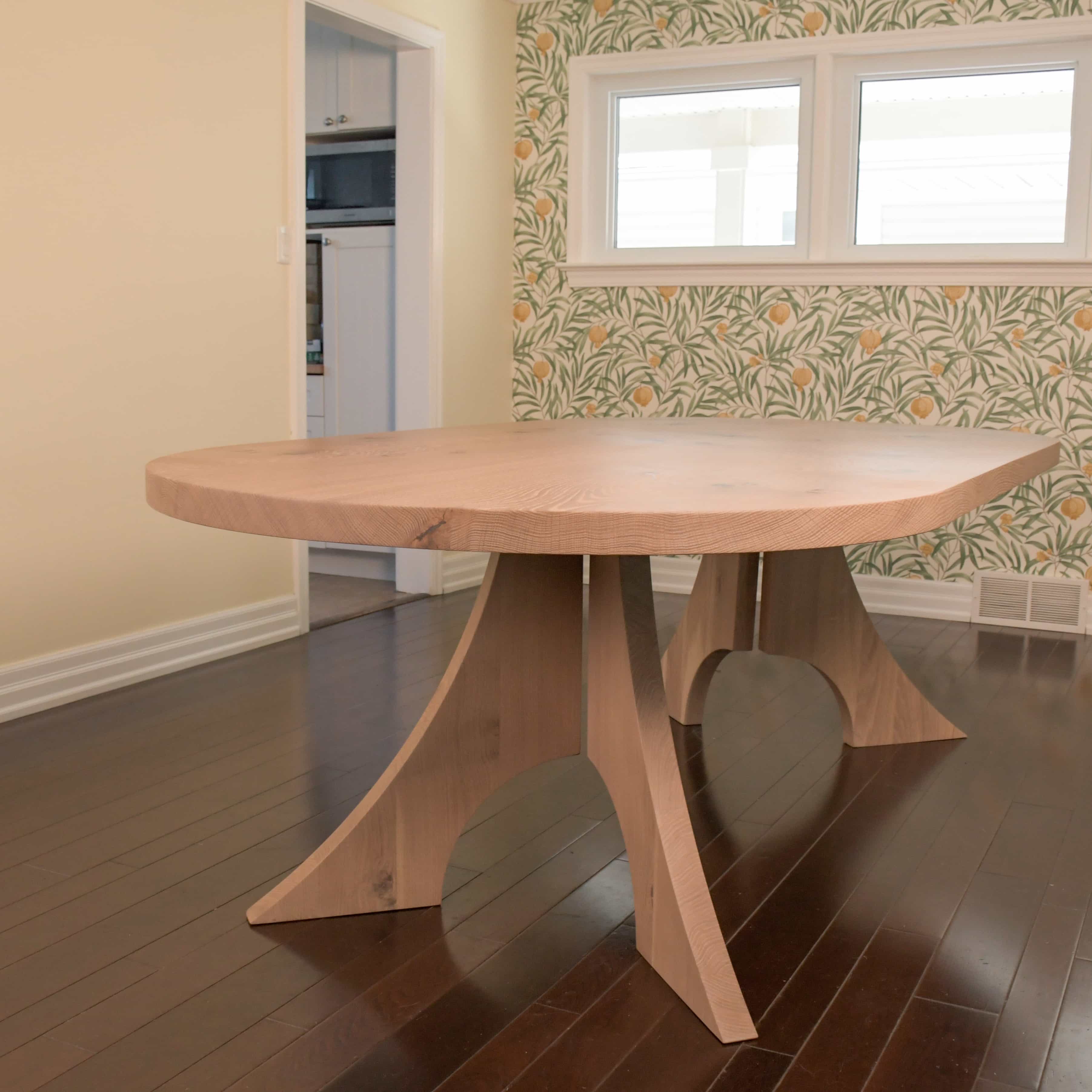 maple racetrack oval bookmatch table in a dining room