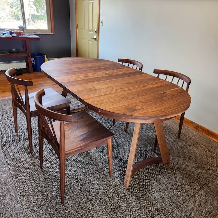 round walnut extending table shown with walnut Eaton chairs