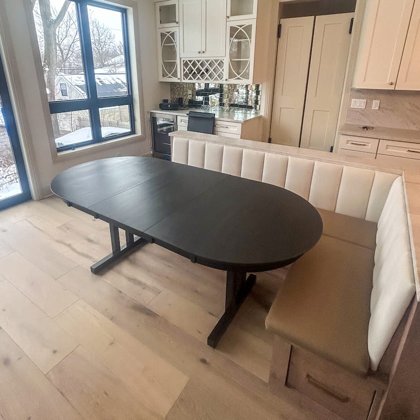 oval maple table with leaves finished in black on steel legs