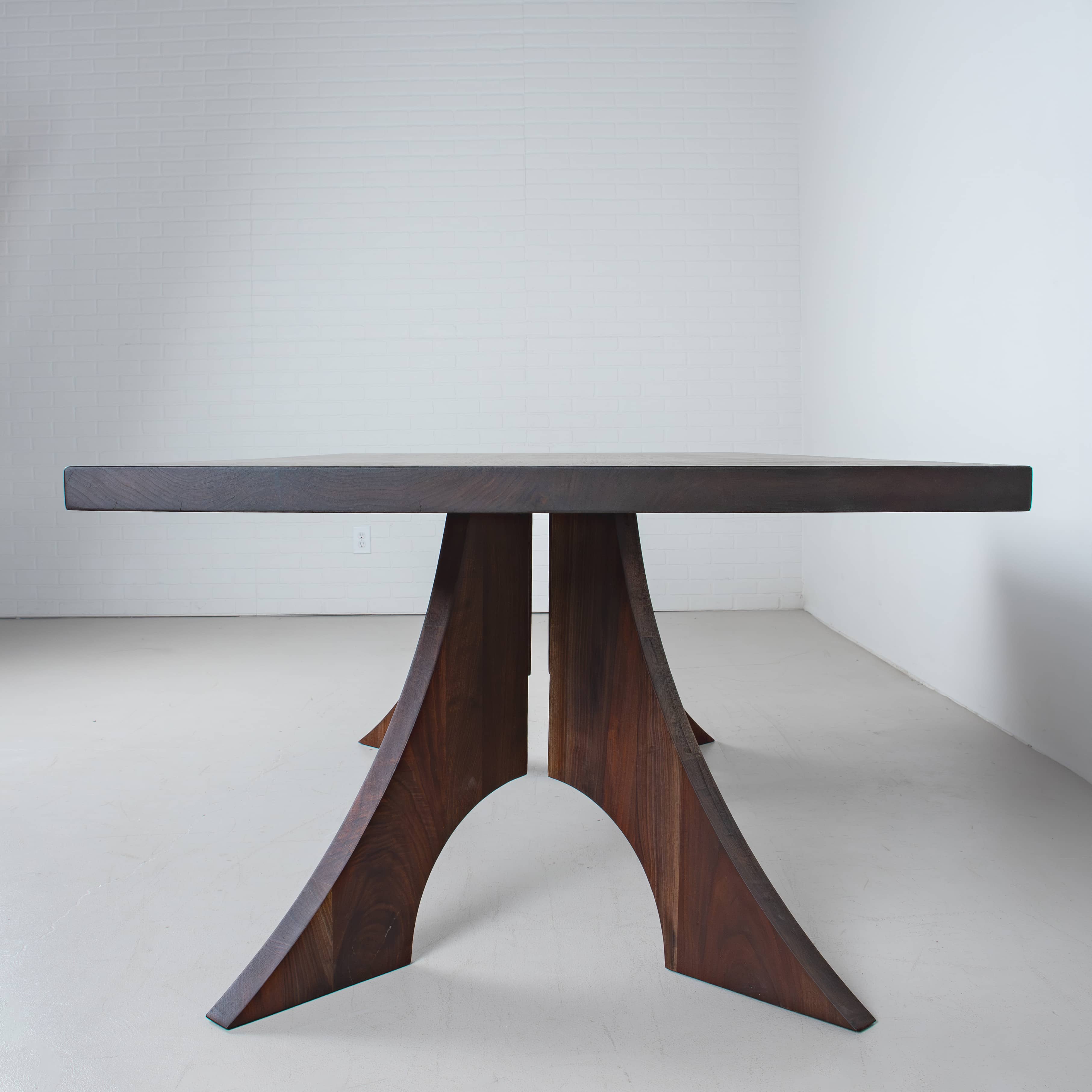 walnut rectangle bookmatch dining table, view from the end to show legs