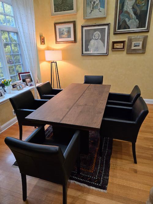 maple dining table with contrasting stripe in dining room with leather chairs
