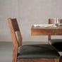 chair placed at the end of a bookmatch Walnut table finished in Pure D 