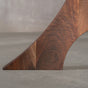 foot detail of an Alta leg in Walnut on a bookmatch Walnut table 