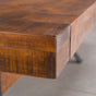 corner detail of an extended rustic maple trestle table finished in cinnamon; 42