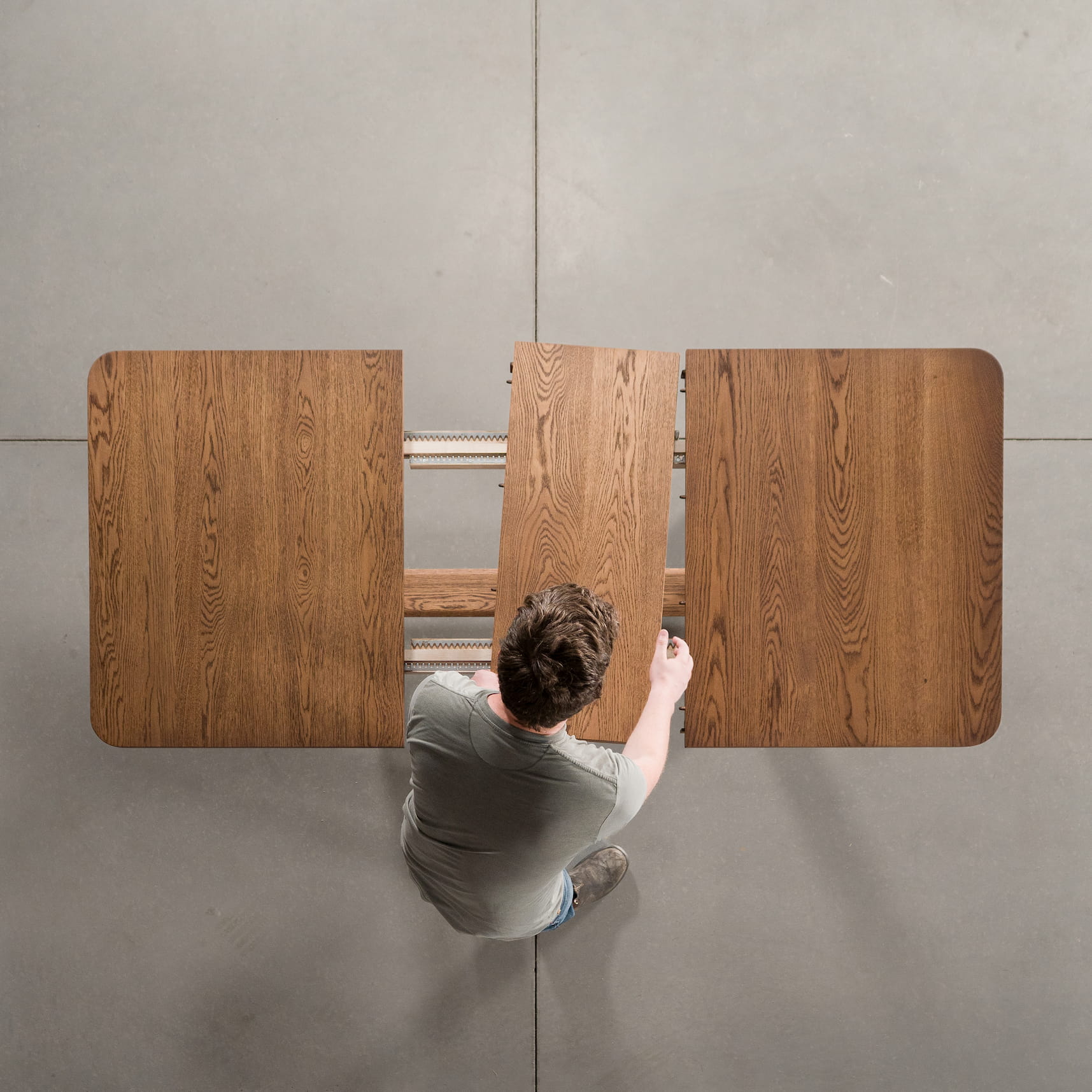 overhead shot of adding a leaf to an Oak extendable table finished in Cortado D