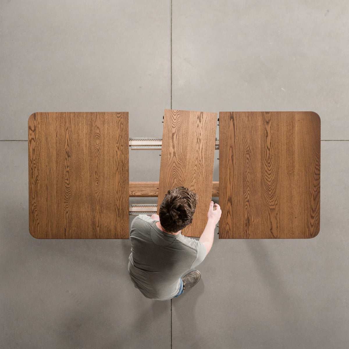 overhead shot of adding a leaf to an Oak extendable table finished in Cortado D