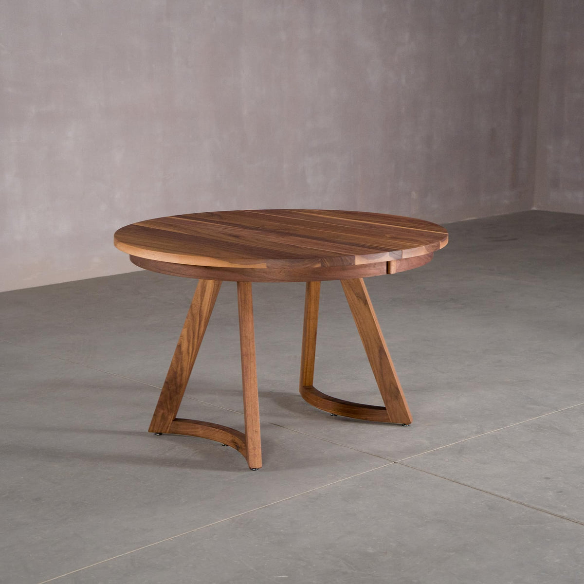round extendable Walnut table 48” wide x 48” long, finished in Pure D on Chesbro legs