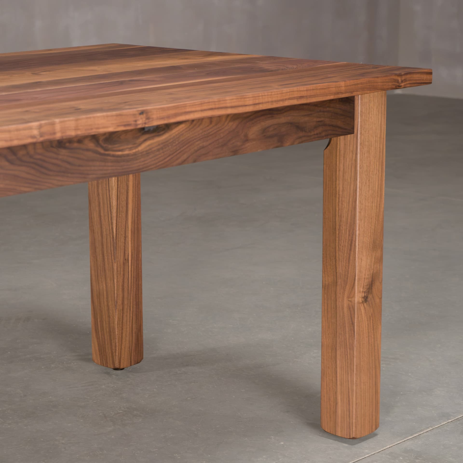 the skirt, leg and corner of a Parker base in Walnut finished in Pure D