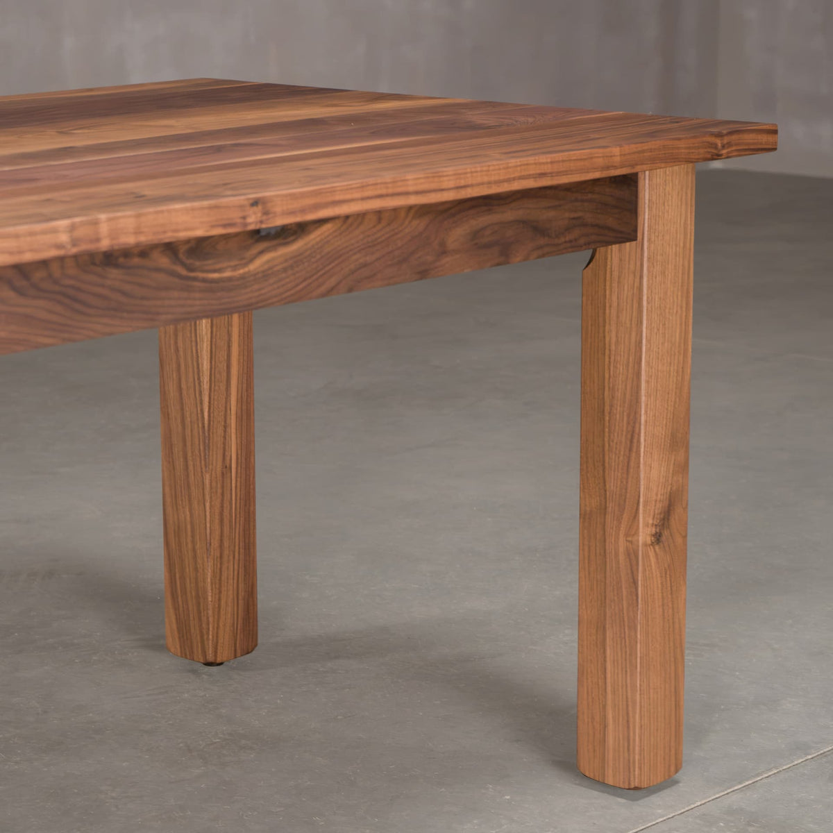 the skirt, leg and corner of a Parker base in Walnut finished in Pure D
