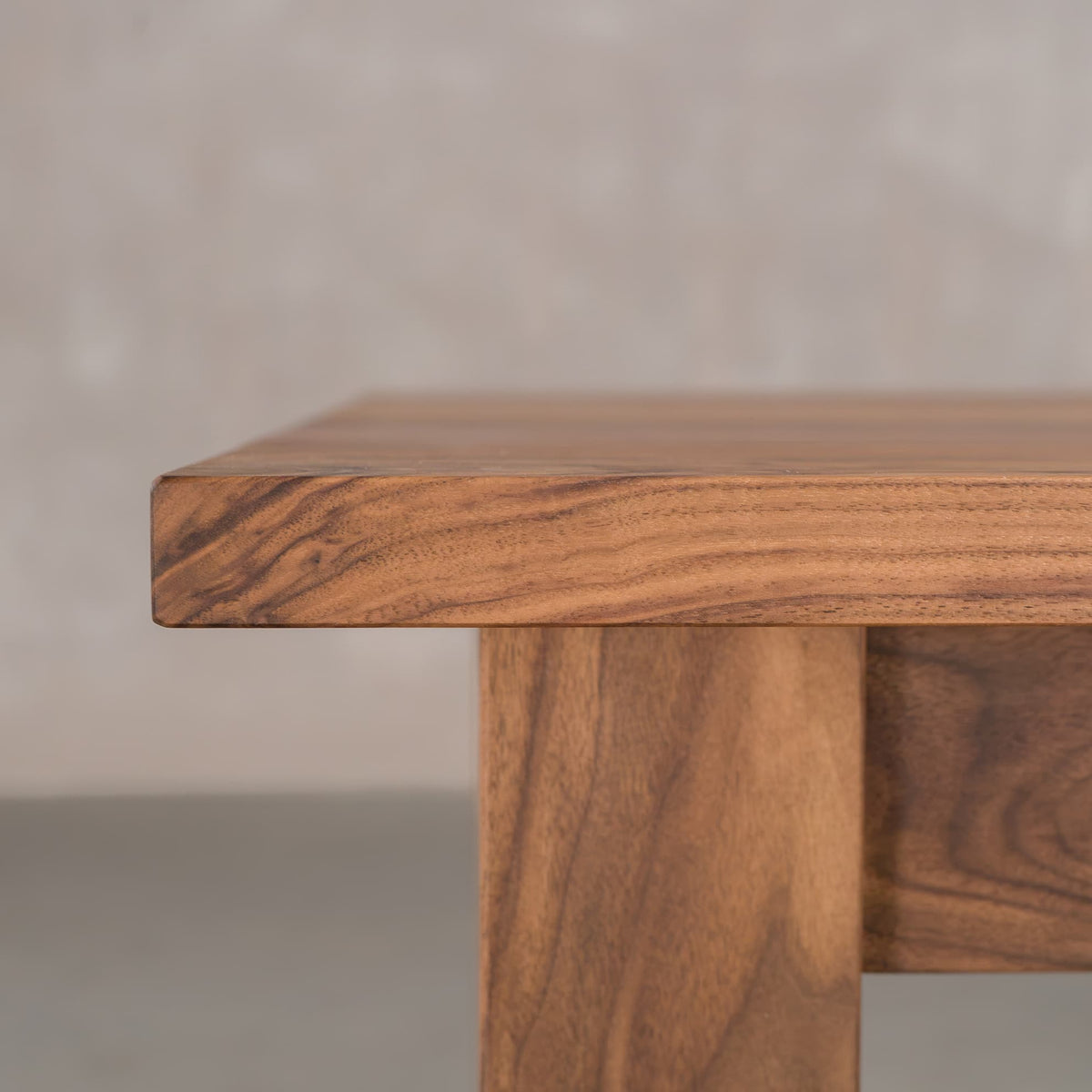 the Seymour edge of rectangle Walnut table finished in Pure D on Parker base