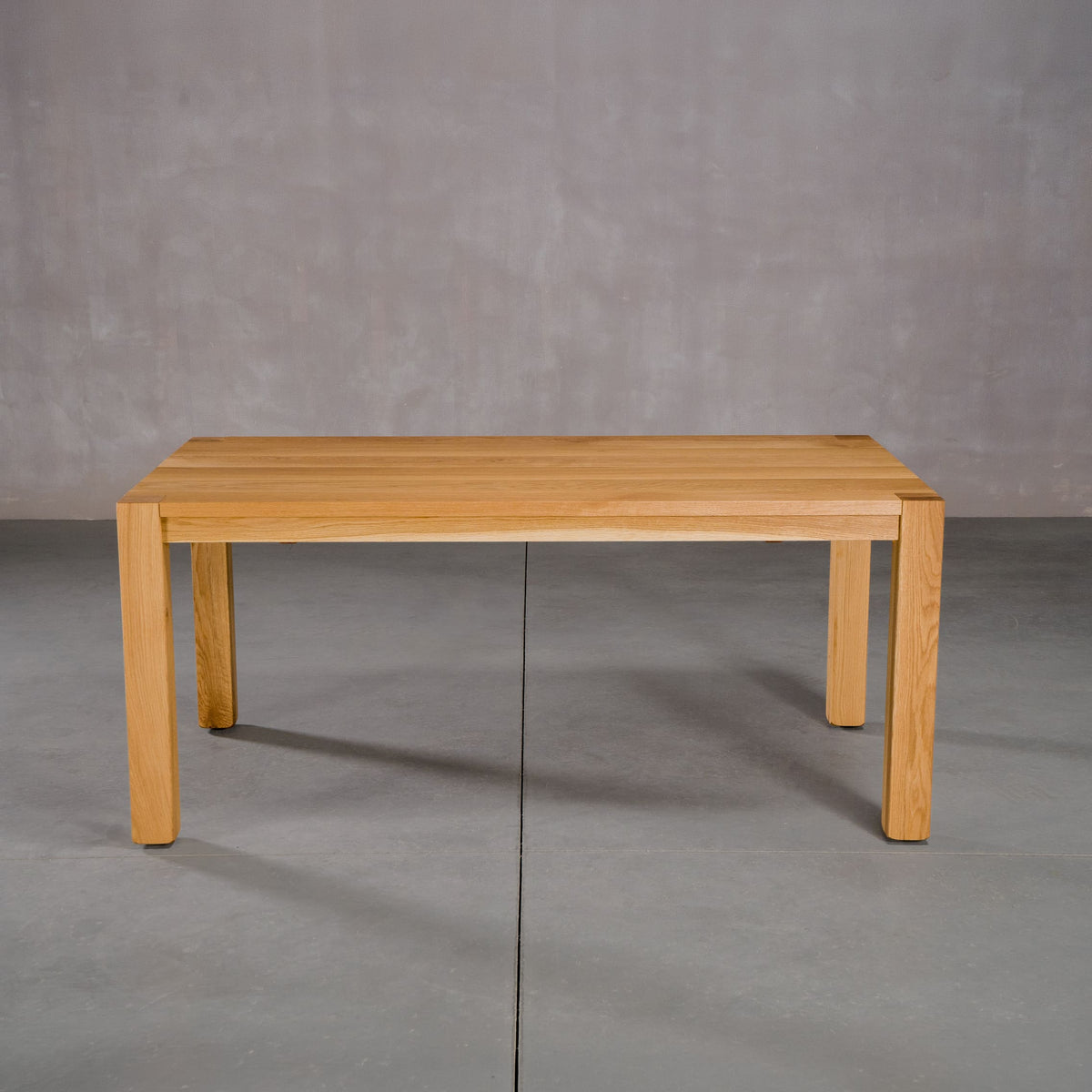 extendable Oak Parsons table 36” wide x 68” long, finished in Pure D on Estling base