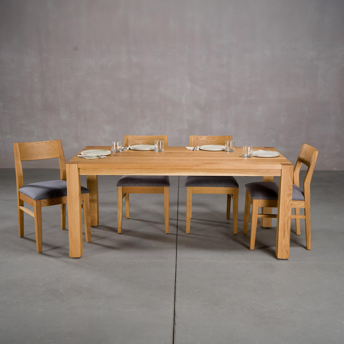 extendable Oak Parsons table 36” wide x 68” long, finished in Pure D on Estling base; shown with Aubrey chairs