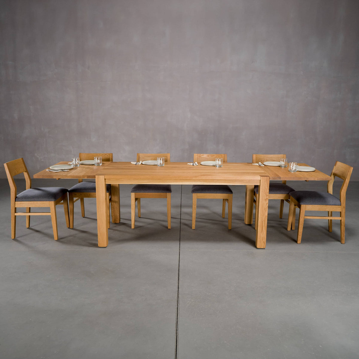 extendable Oak Parsons table 36” wide x 68” long with 2-18