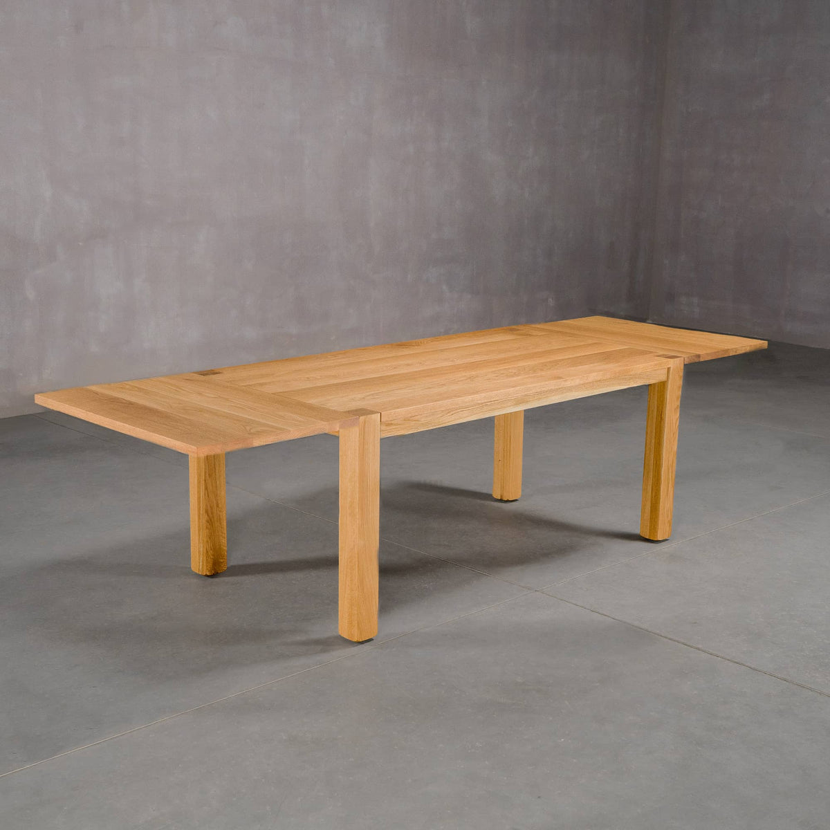 extendable Oak Parsons table 36” wide x 68” long with 2-18