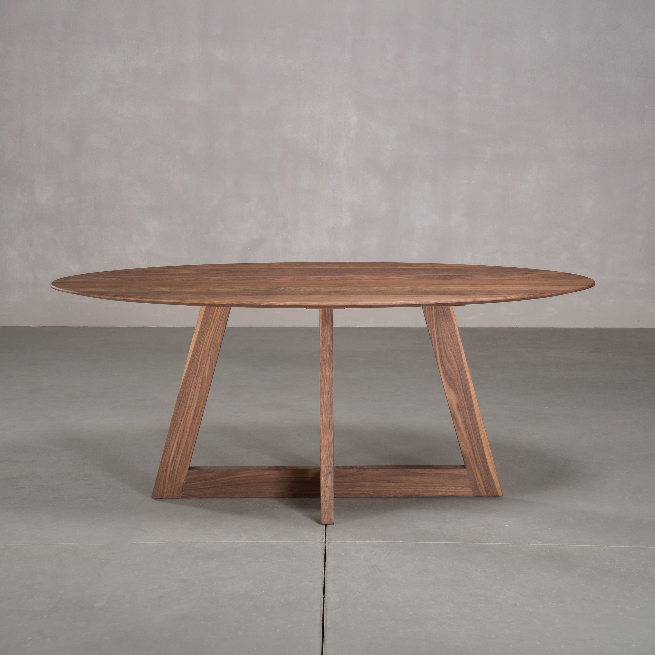 elliptical Walnut table 36” wide x 72” long, finished in Pure D on Moraine base
