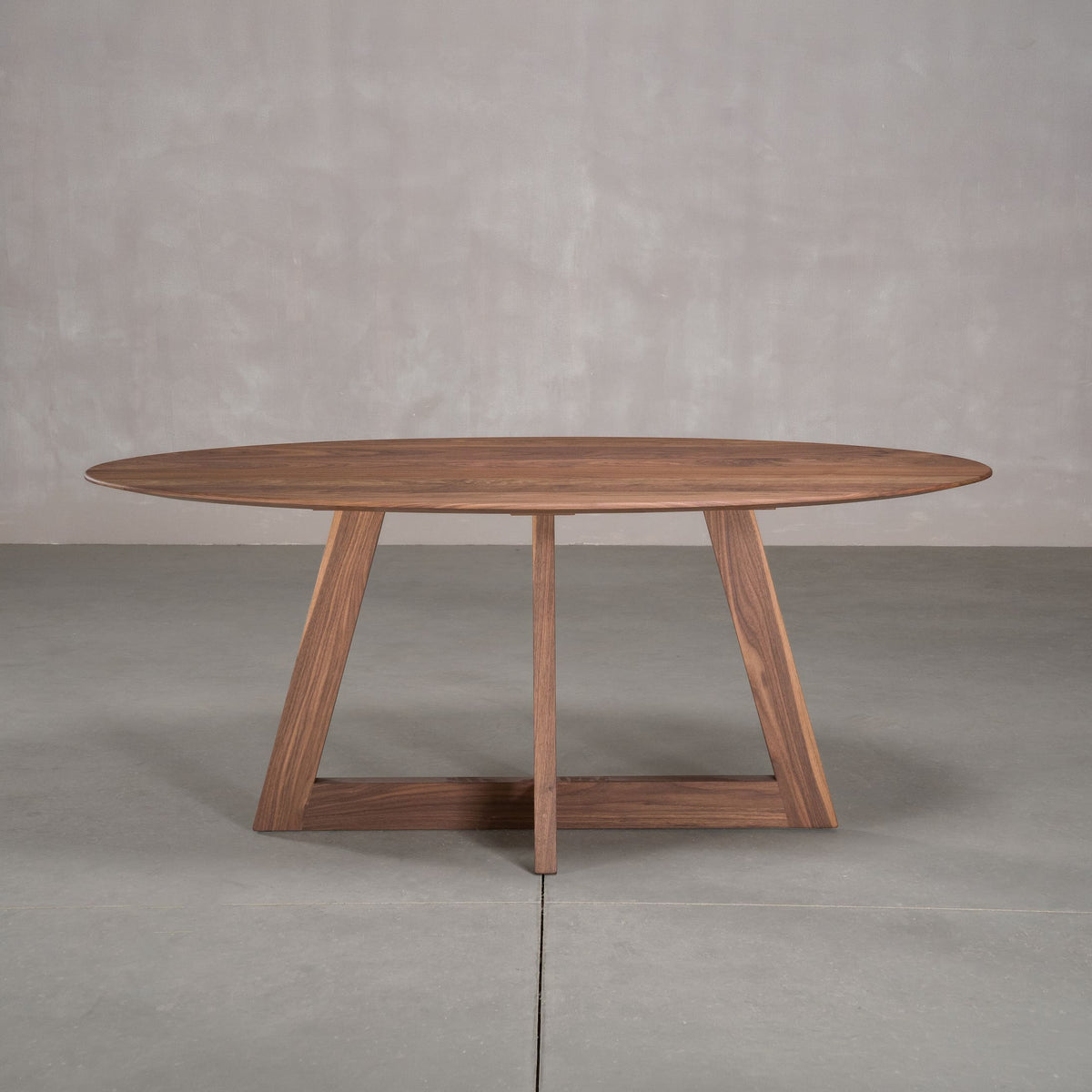elliptical Walnut table 36” wide x 72” long, finished in Pure D on Moraine base