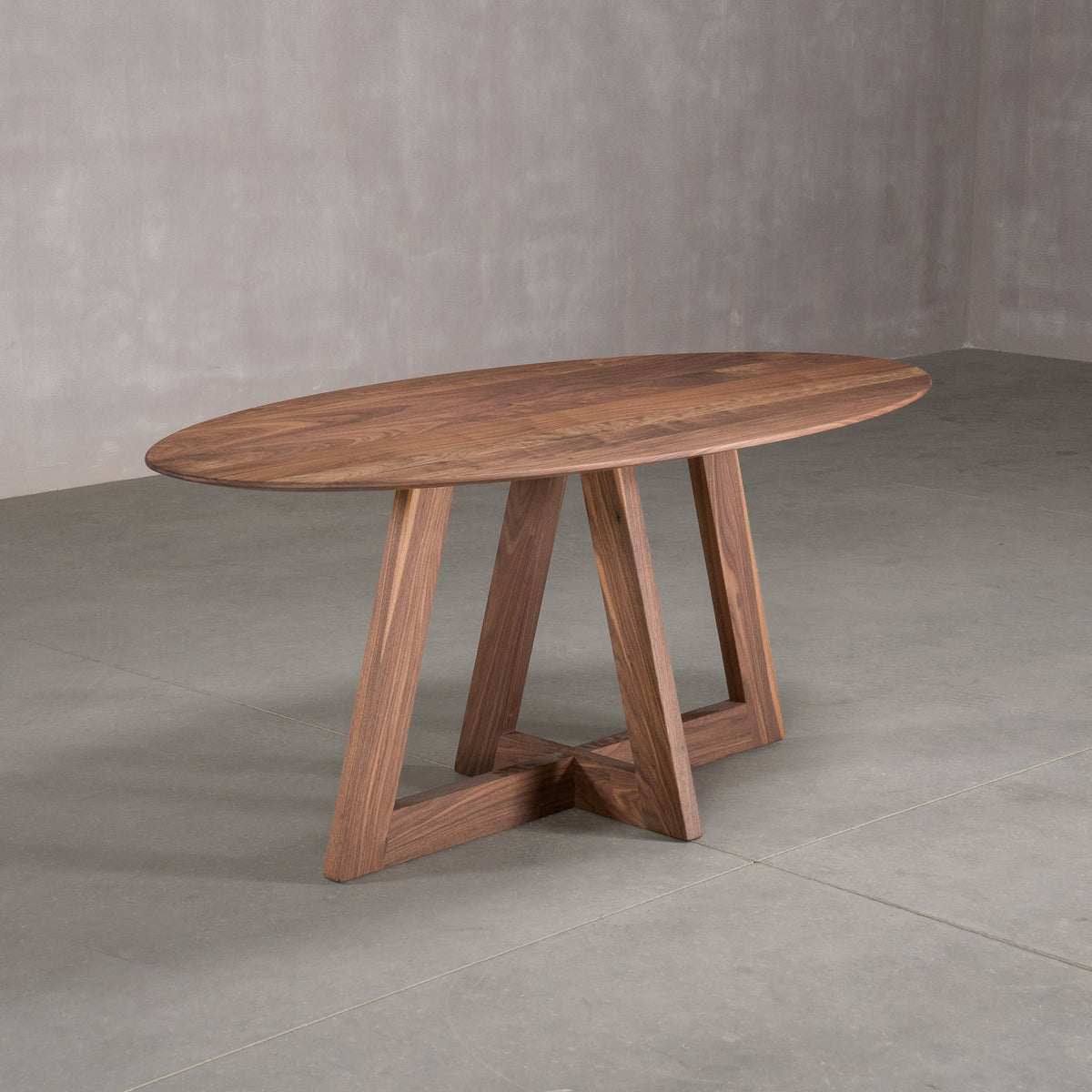 elliptical Walnut table 36” wide x 72” long, finished in Pure D on Moraine base