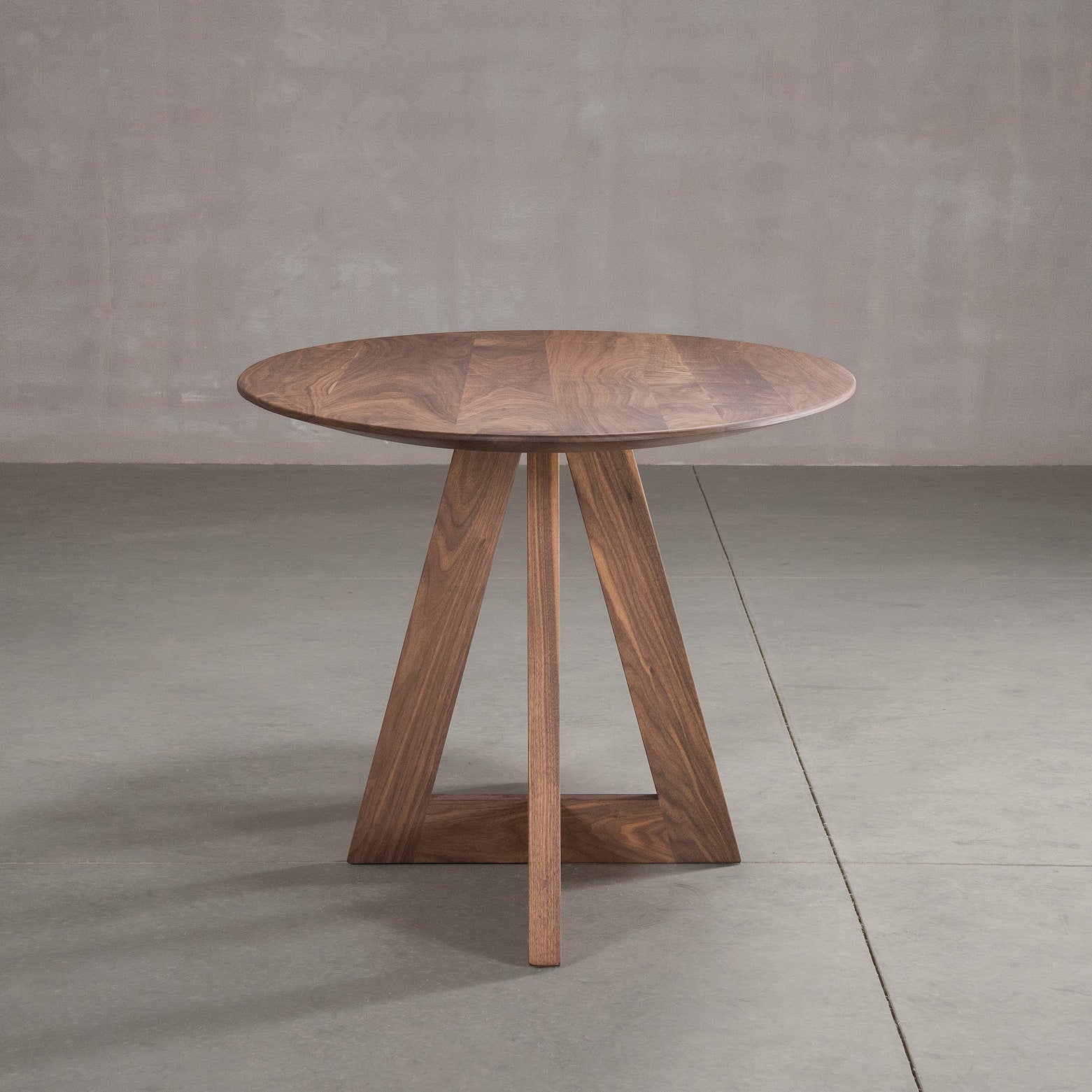 end view of elliptical Walnut table 36” wide x 72” long, finished in Pure D on Moraine base