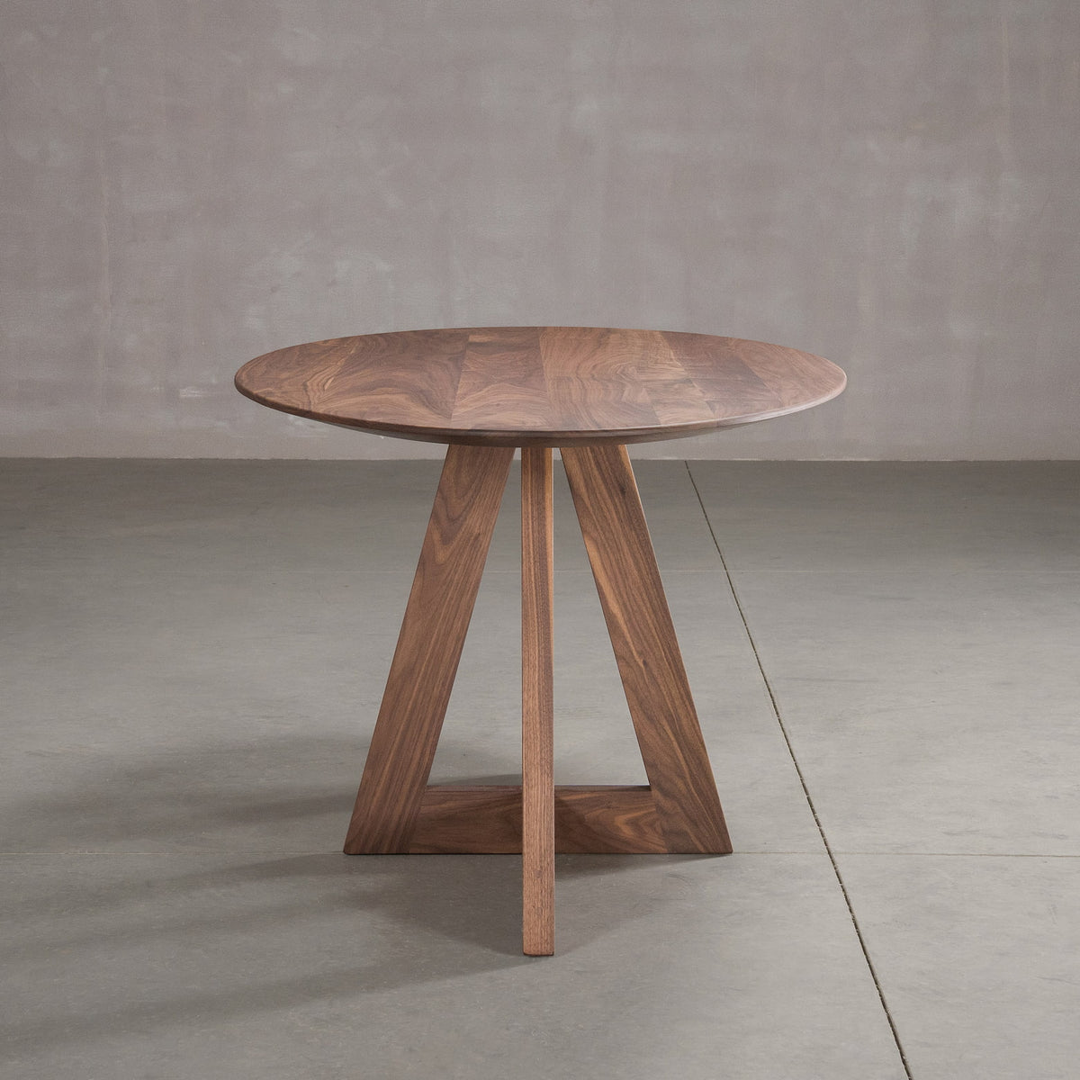 end view of elliptical Walnut table 36” wide x 72” long, finished in Pure D on Moraine base
