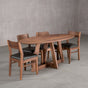 elliptical Walnut table 36” wide x 72” long, finished in Pure D on Moraine base; shown with Walnut Aubrey chairs