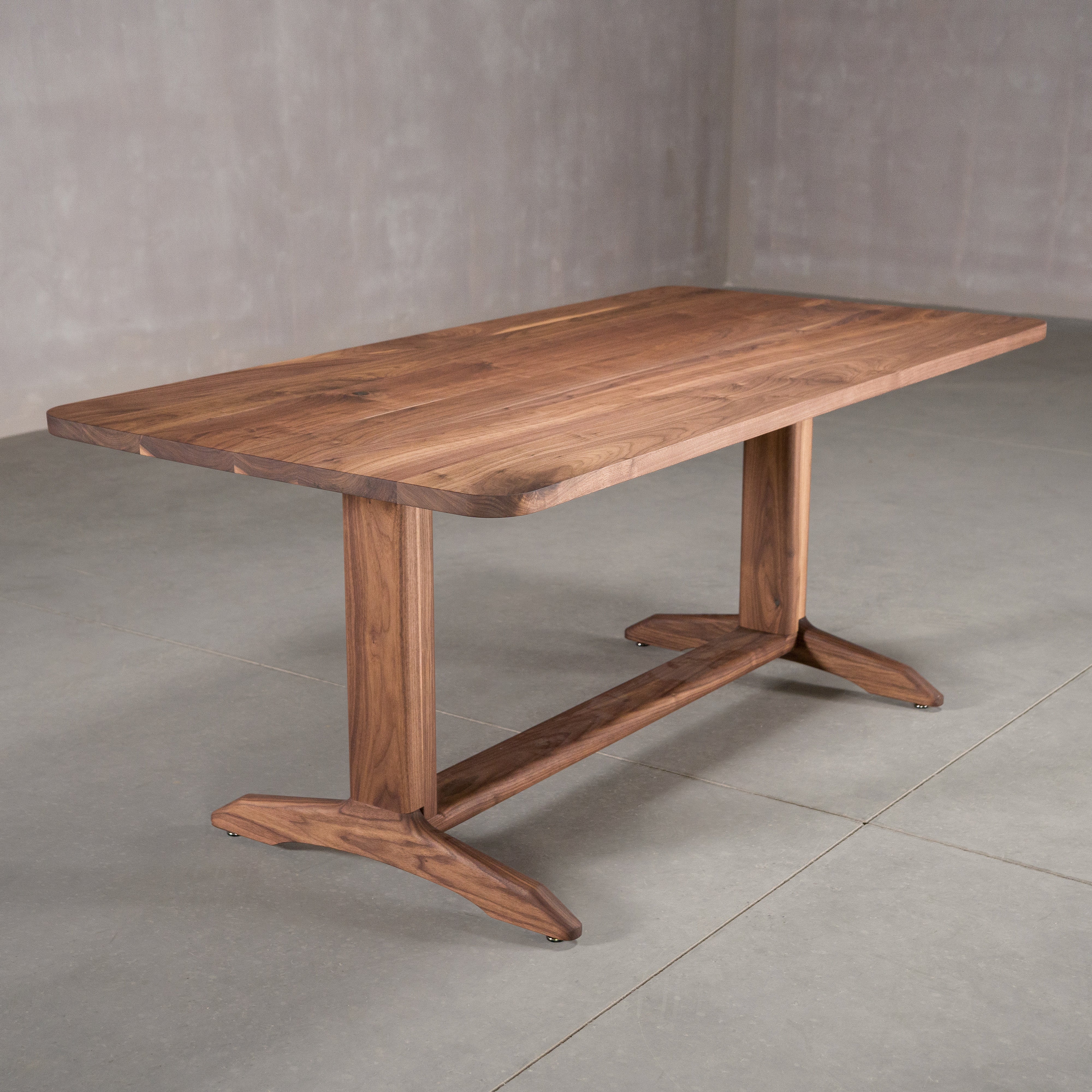 rectangle Walnut table 36” wide x 72” long, finished in Pure D on Tobin trestle base
