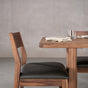 chair at end of a rectangle Walnut table 36” wide x 72” long, finished in Pure D on Tobin trestle base