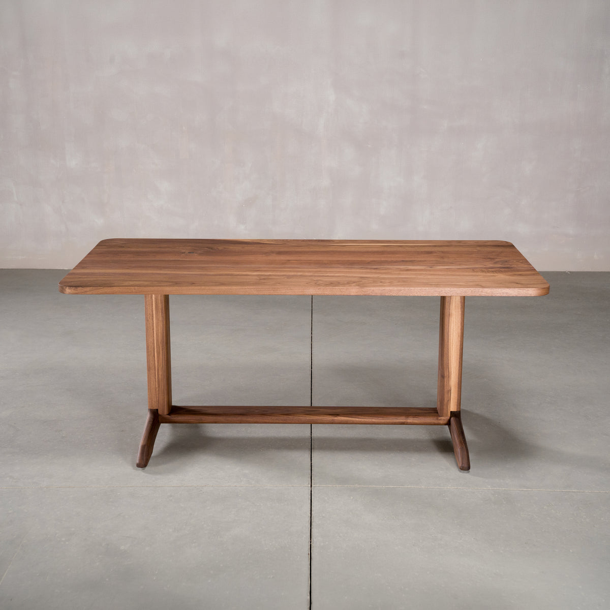 rectangle Walnut table 36” wide x 72” long, finished in Pure D on Tobin trestle base