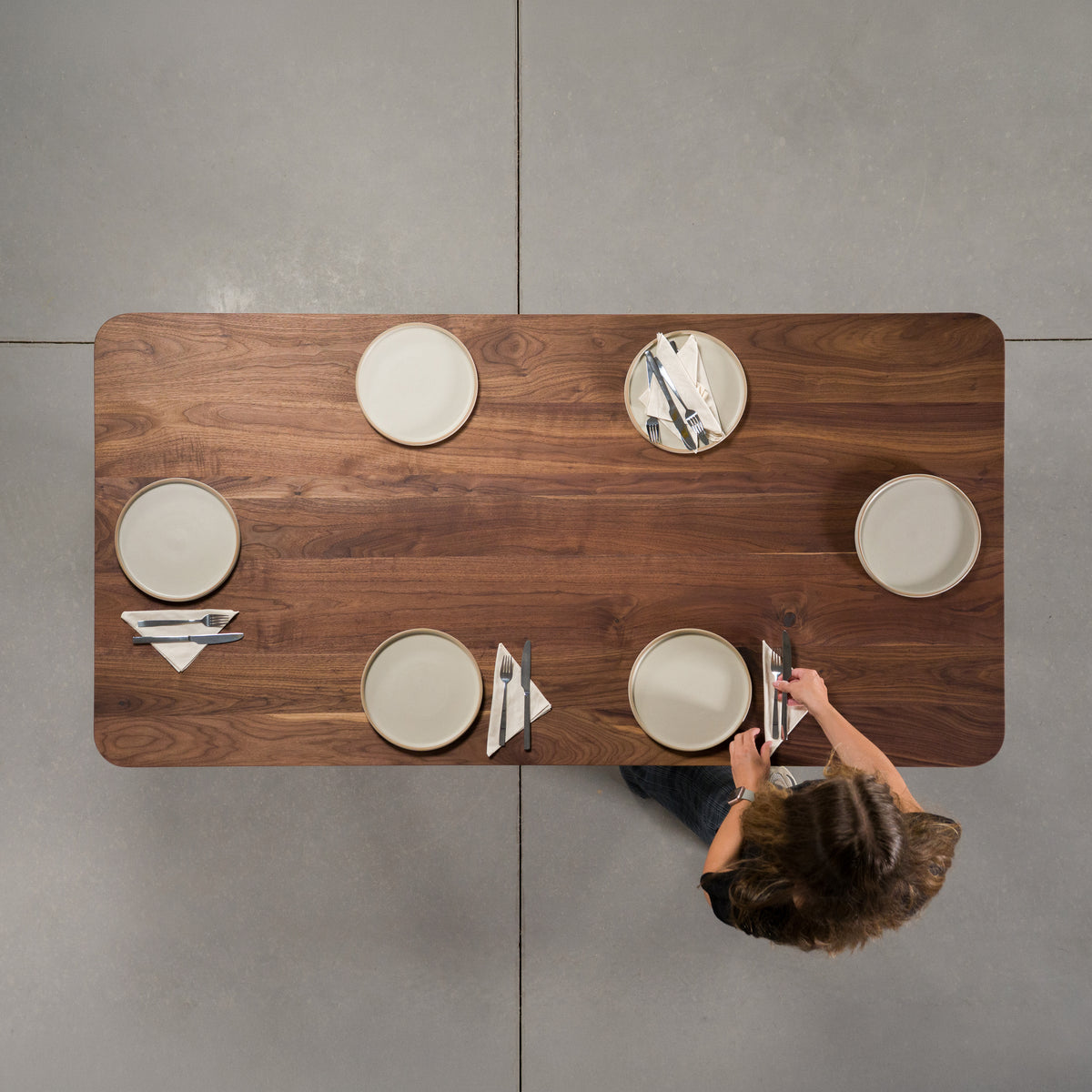 seating at a rectangle Walnut table 36” wide x 72” long, finished in Pure D with rounded corners