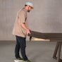 person adding a leaf to an extendable Red Oak table finished in Dark Roast W on Caldwell legs