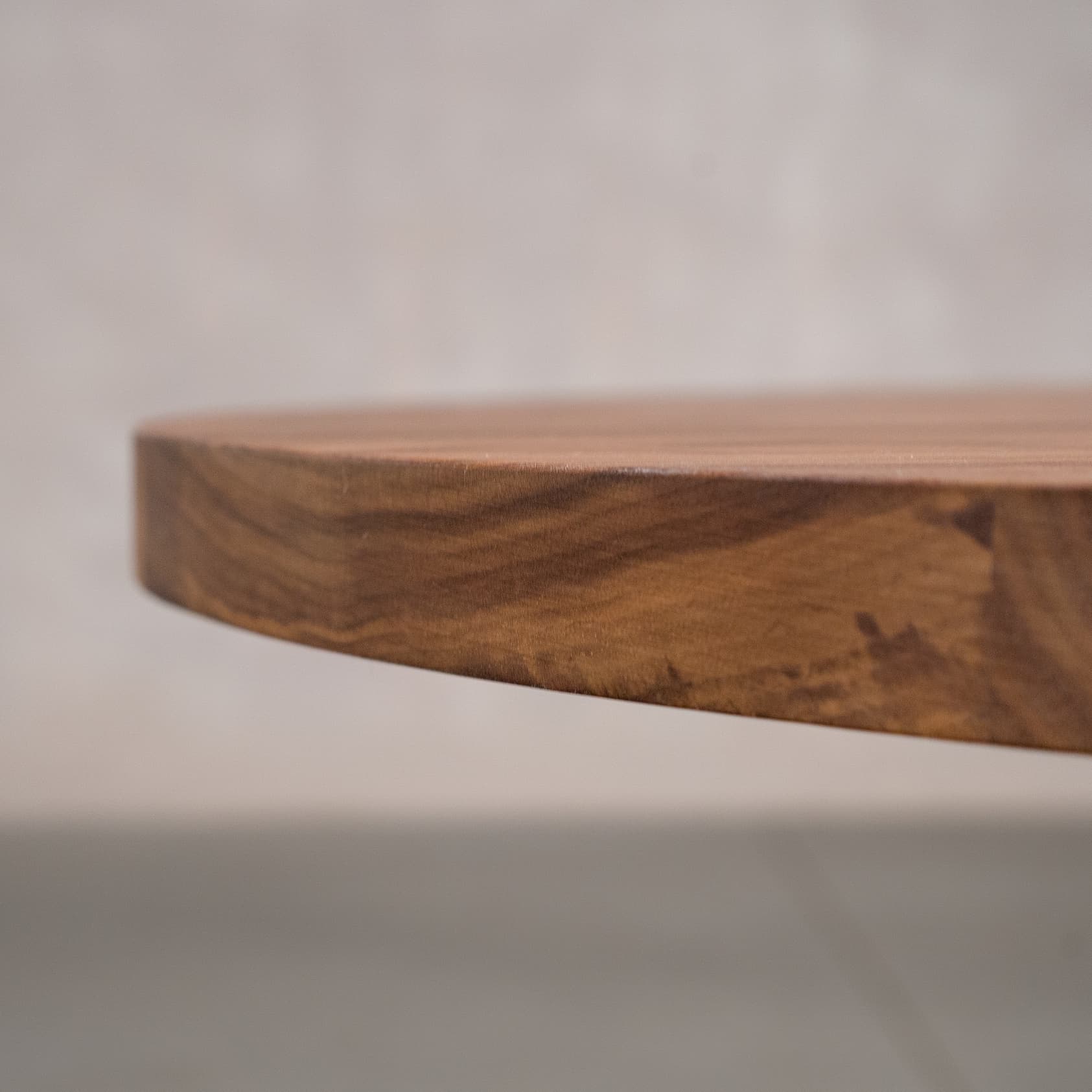 the Seymour edge on a nelliptical Walnut table finished in Pure D 