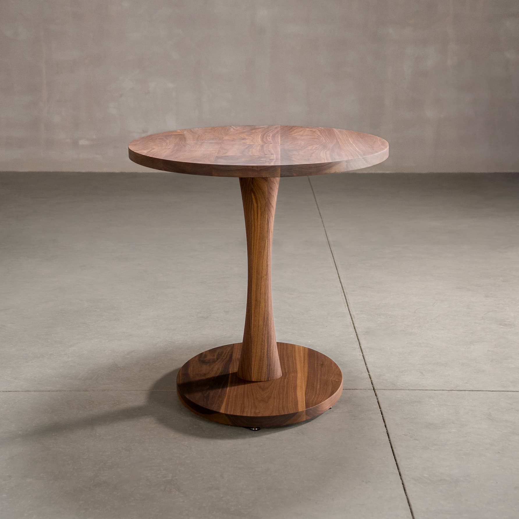elliptical Walnut table 30” wide x 48” long, finished in Pure D on a Jennings pedestal base