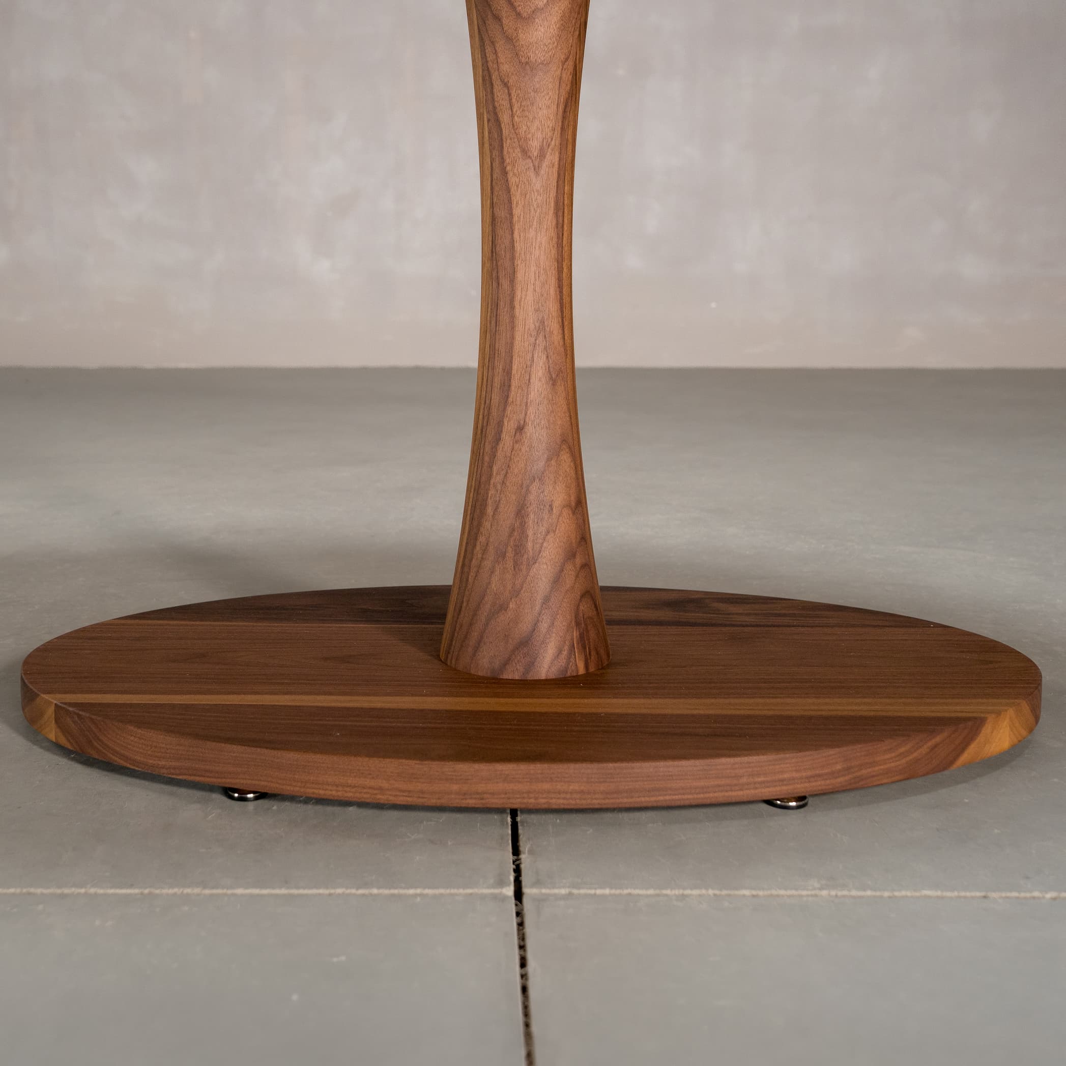 the Jennings pedestal base on an elliptical Walnut table finished in Pure D 