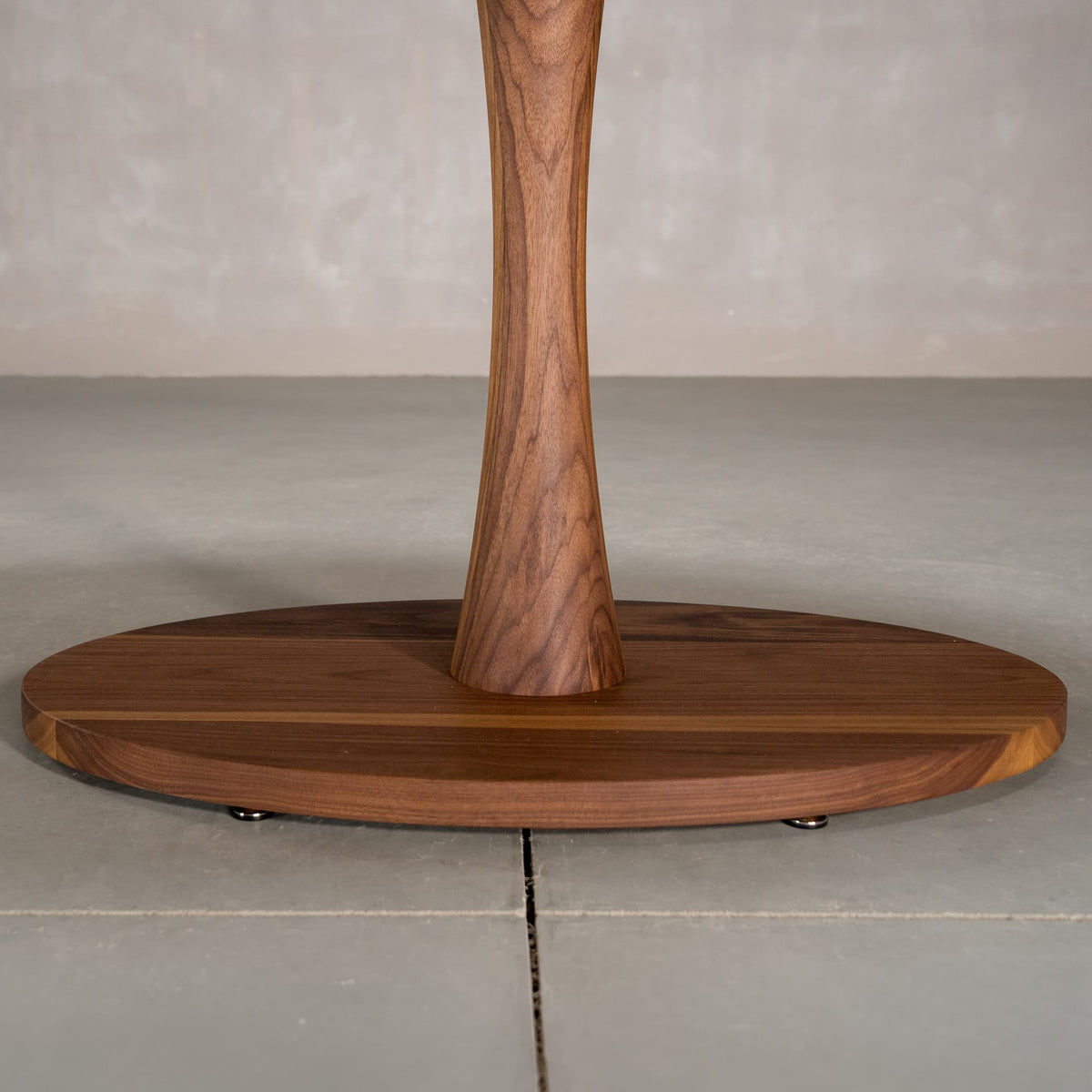 the Jennings pedestal base on an elliptical Walnut table finished in Pure D 