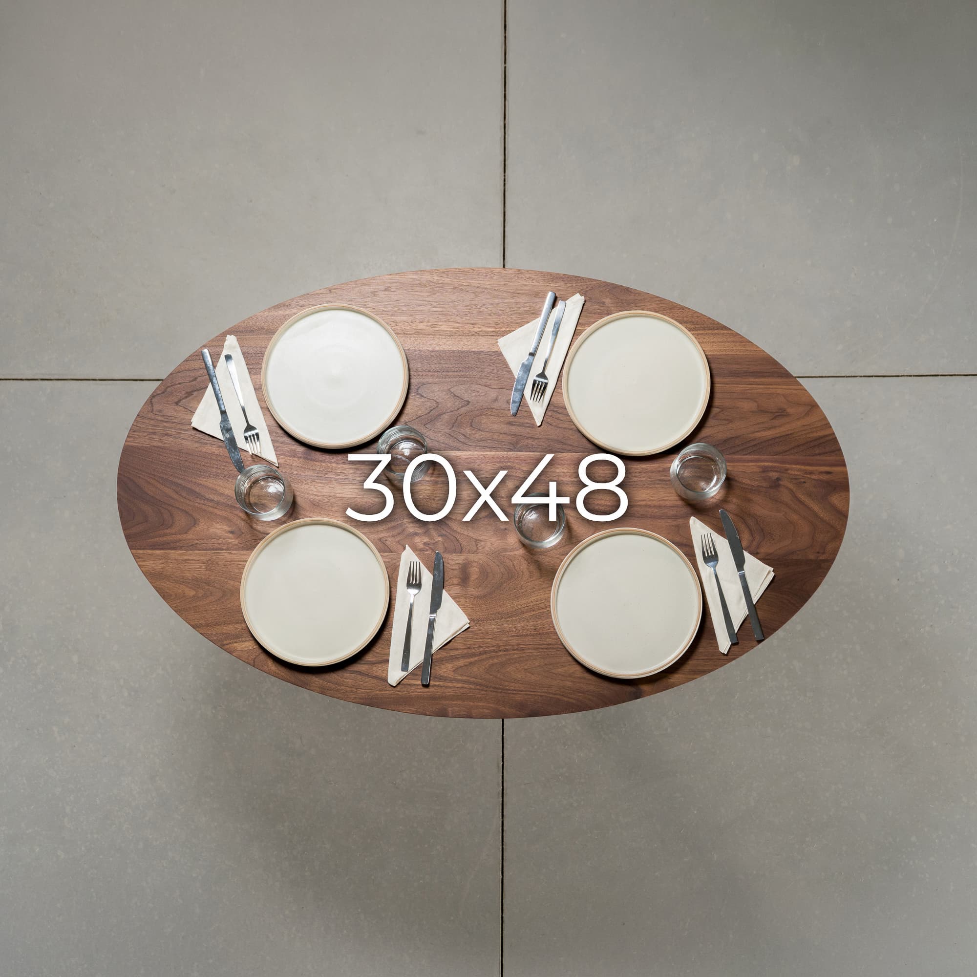 overhead view showing seating at an elliptical Walnut table 30” wide x 48” long, finished in Pure D